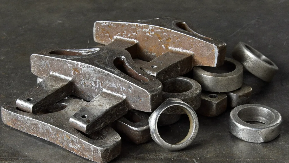 Flange e anelli in acciaio lavorati accatastati su un banco metallico